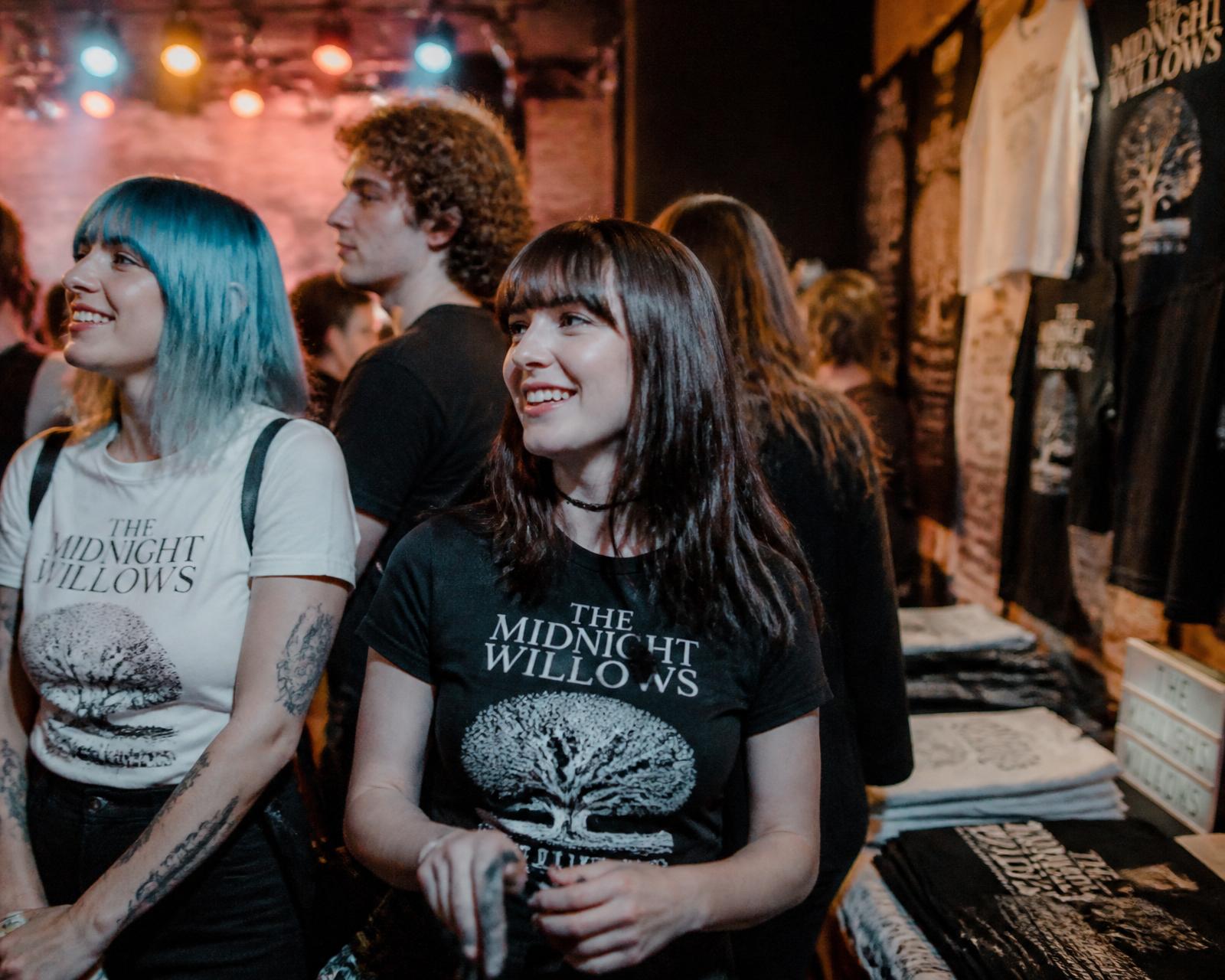 Fans wearing custom band t-shirts printed by CC Print at a live show